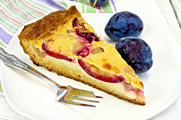 Image showing Pie plum with sour cream in white plate on board