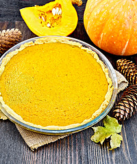 Image showing Pie pumpkin in pan on dark board