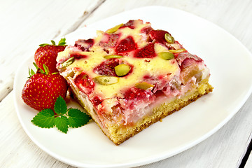 Image showing Pie strawberry-rhubarb with sour cream and berries on light boar