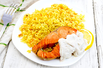 Image showing Salmon with lemon and rice on light board