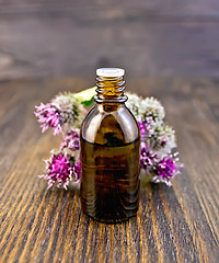 Image showing Oil with burdock in vial on board