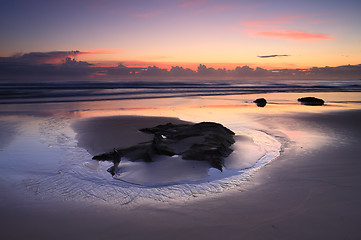 Image showing Sunrise reflections on the beach