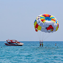 Image showing Parasailing in a blue sky 