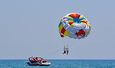 Image showing Parasailing in a blue sky 