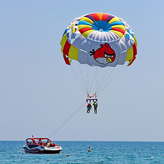 Image showing Parasailing in a blue sky 