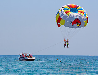 Image showing Parasailing in a blue sky 