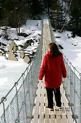 Image showing Woman on suspension bridge