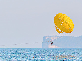 Image showing Parasailing in a blue sky