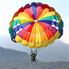 Image showing Parasailing in a blue sky