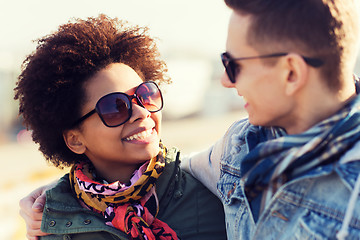 Image showing happy teenage friends in shades talking outdoors