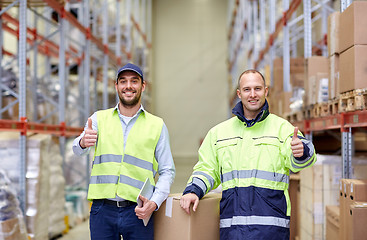 Image showing men with boxes showing thumbs up at warehouse