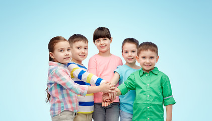 Image showing happy little children with hands on top over blue