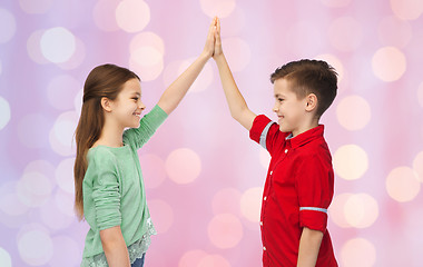 Image showing happy boy and girl making high five