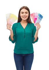 Image showing smiling young woman with color swatches