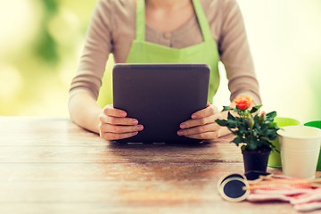 Image showing close up of woman or gardener holding tablet pc