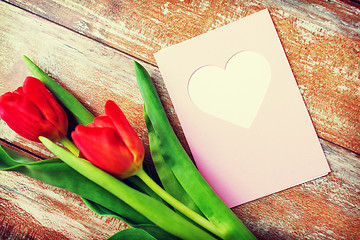 Image showing close up of tulips and greeting card with heart