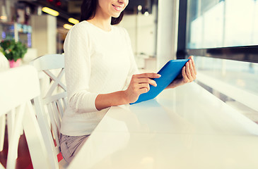 Image showing close up of woman with tablet pc at cafe