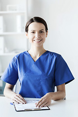 Image showing happy doctor or nurse with clipboard at hospital