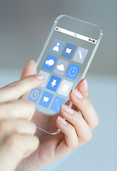 Image showing close up of woman with app icons on smartphone