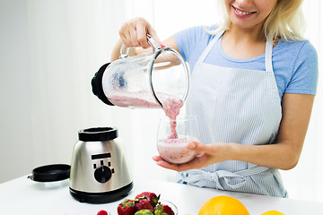 Image showing close up of woman with blender and shake at home