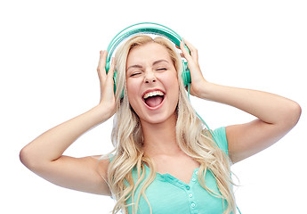 Image showing happy young woman or teenage girl with headphones