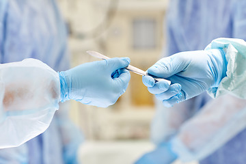 Image showing close up of hands with scalpel at operation