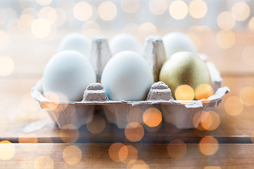 Image showing close up of white and gold eggs in egg box