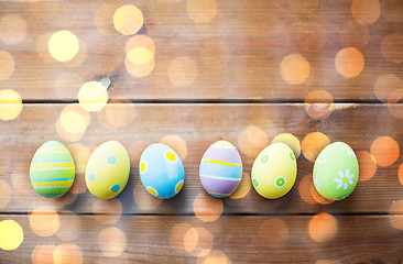 Image showing close up of colored easter eggs on wooden surface