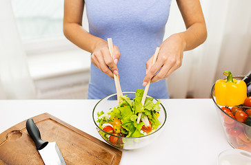 Image showing close up of woman cooking vegetable salad at home