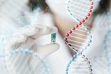 Image showing close up of scientist holding pill in lab