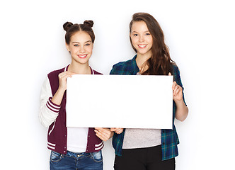 Image showing smiling teenage girls holding white blank board