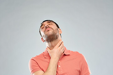 Image showing man touching neck and suffering from throat pain