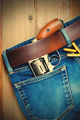 Image showing old silver revolver and vintage blue jeans