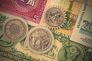 Image showing Coins gear on the background of banknotes