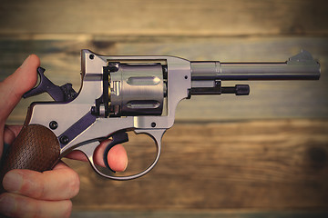 Image showing human hand with revolver