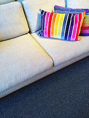 Image showing Sofa with bright rainbow striped cushions