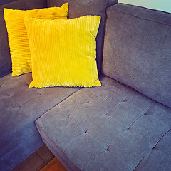 Image showing Corner sofa with bright yellow cushions