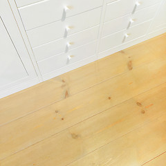 Image showing White dresser on wooden floor