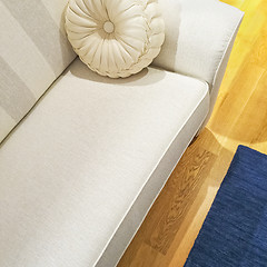 Image showing White sofa with a fancy cushion