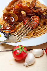 Image showing Italian seafood spaghetti pasta on red tomato sauce 