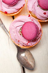 Image showing pink berry cream cupcake with macaroon on top