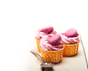 Image showing pink berry cream cupcake with macaroon on top