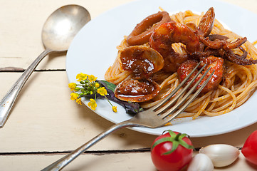 Image showing Italian seafood spaghetti pasta on red tomato sauce 