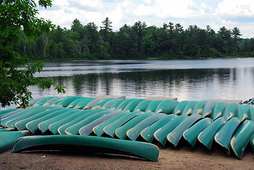 Image showing Canoes on lake shore