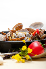 Image showing fresh clams on an iron skillet