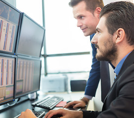 Image showing Stock traders looking at computer screens.