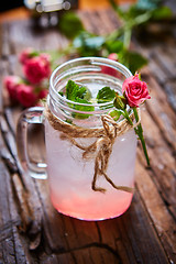 Image showing fresh mojito on a rustic table.