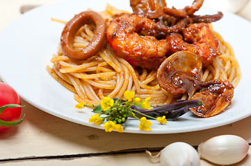 Image showing Italian seafood spaghetti pasta on red tomato sauce 