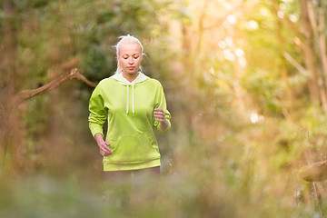 Image showing Pretty young girl runner in the forest. 