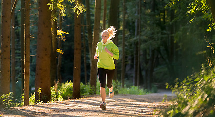 Image showing Pretty young girl runner in the forest. 